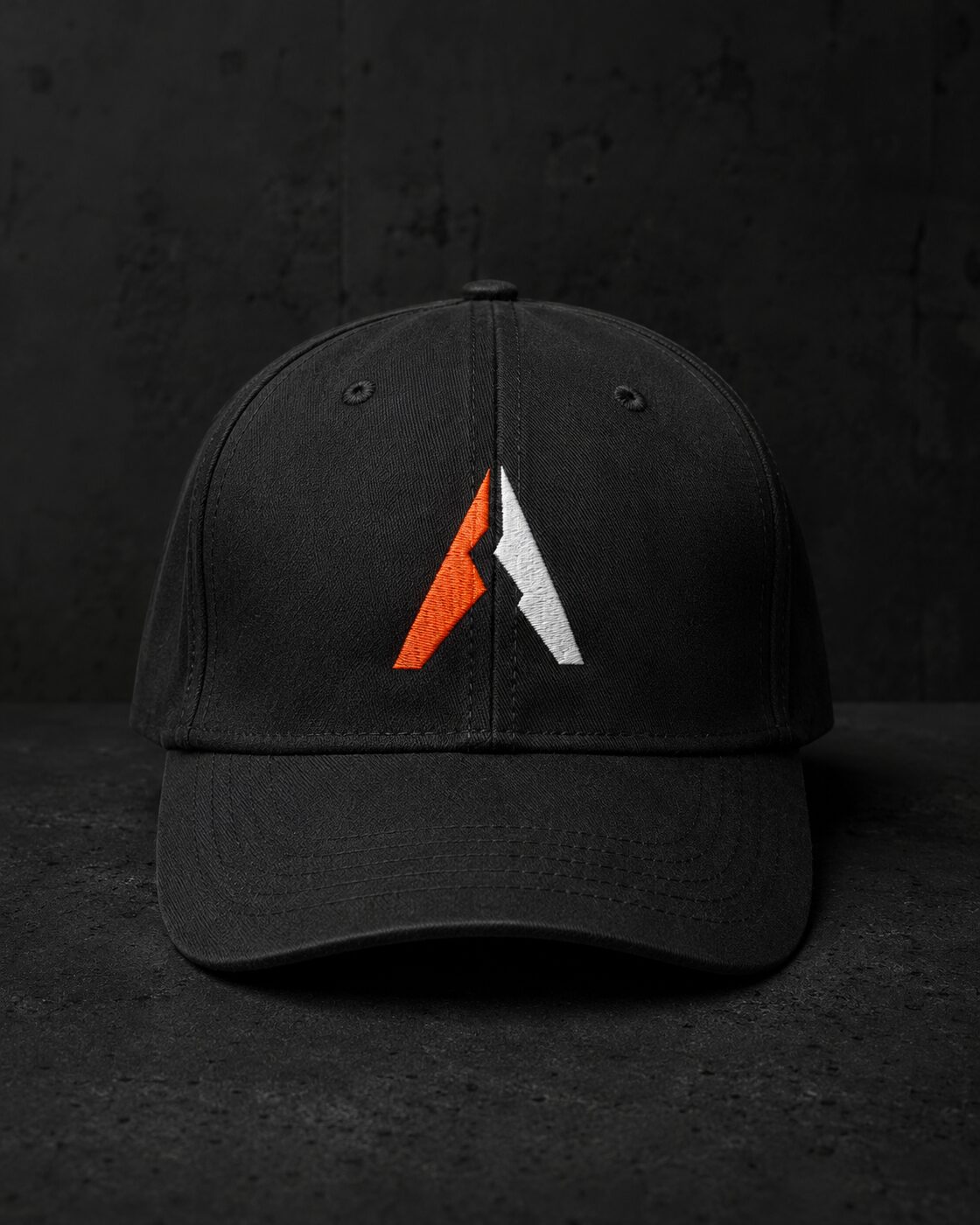 Black unstructured 6-panel cap with embroidered volcano symbol.