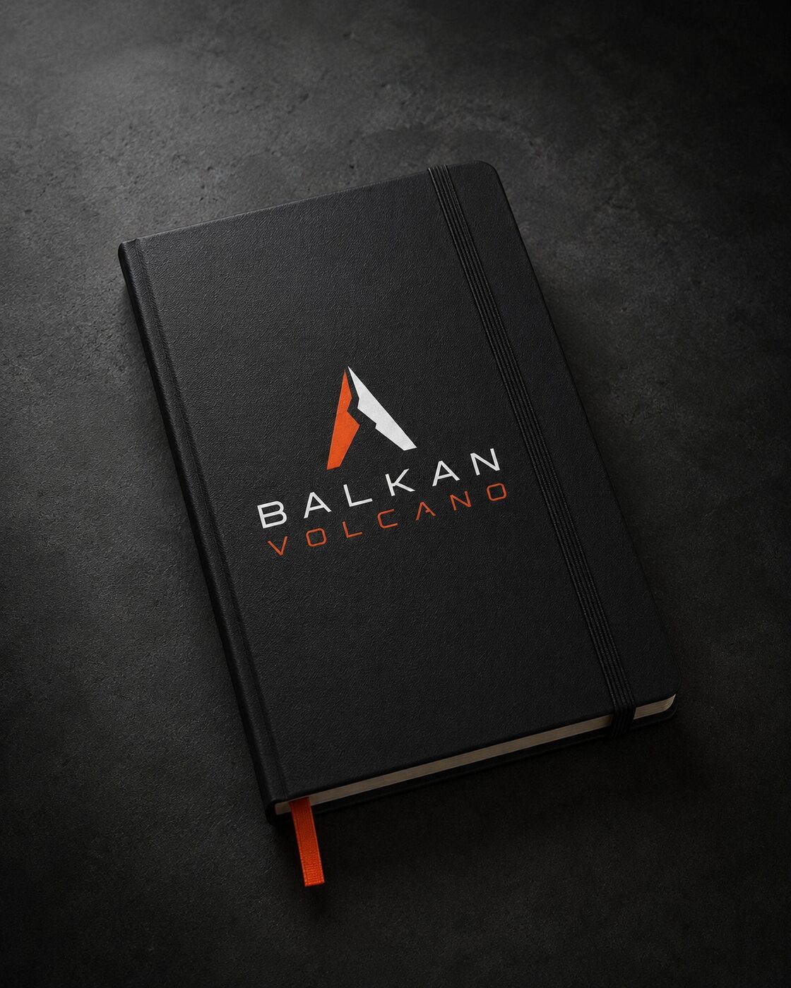 Hardcover Assumption Book notebook with foiled Balkan Volcano logo.